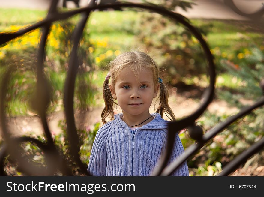 Beautiful girl's portrait in a heart frame in summertime. Beautiful girl's portrait in a heart frame in summertime