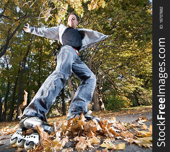 Wide-angle shot of a sliding rollerskater - strong motion blur on person. Wide-angle shot of a sliding rollerskater - strong motion blur on person