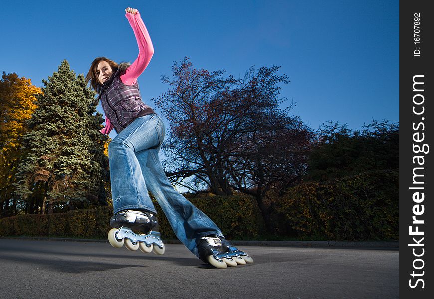 Wide-angle shot of a sliding rollerskater - motion blur on person. Wide-angle shot of a sliding rollerskater - motion blur on person