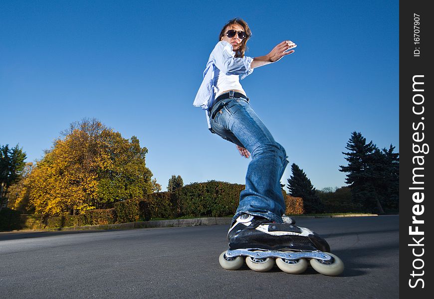 Wide-angle shot of a sliding rollerskater - motion blur on person. Wide-angle shot of a sliding rollerskater - motion blur on person