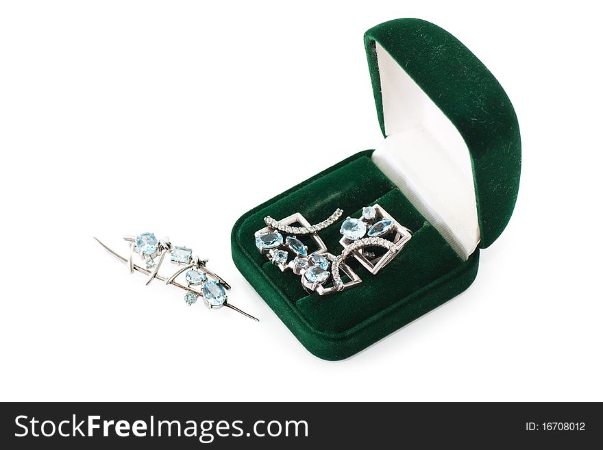 Green gift box with jewels inside isolated over white