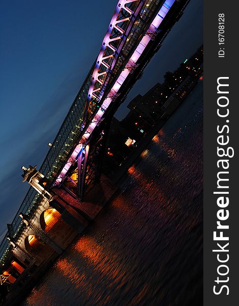 Night bridge and it's light reflections in a river