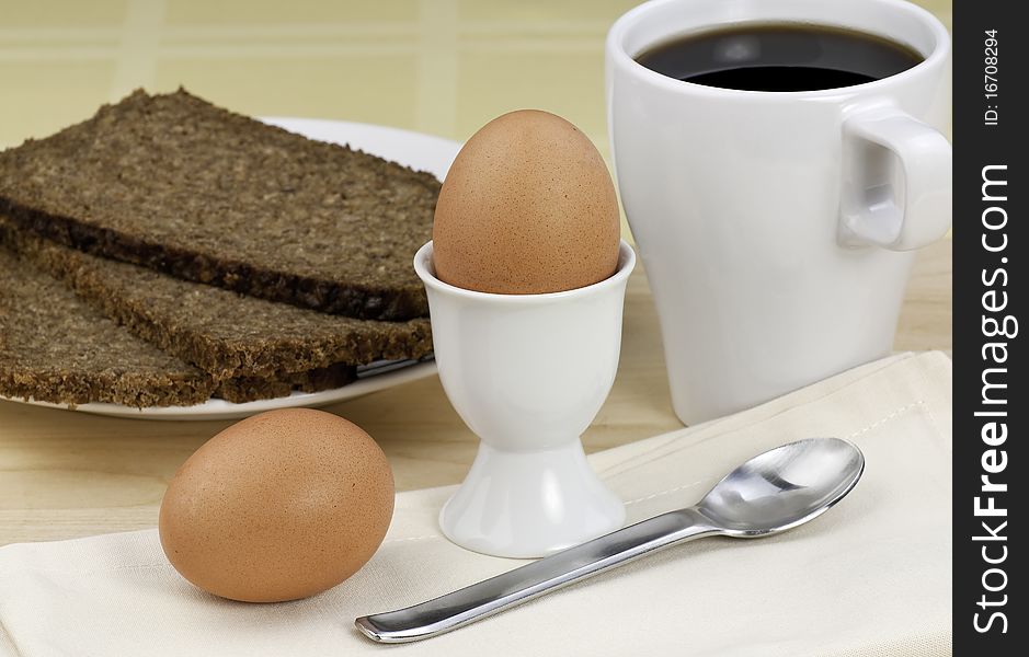 Soft boiled eggs with bread and coffee for a light breakfast. Soft boiled eggs with bread and coffee for a light breakfast