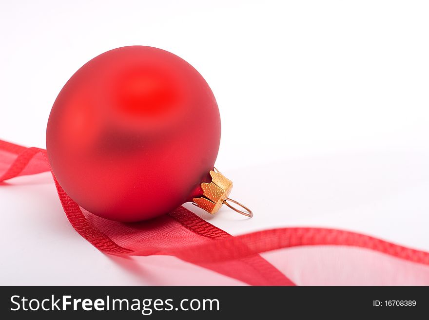 Red bauble with gold stars and red ribbon on a white background. Red bauble with gold stars and red ribbon on a white background.