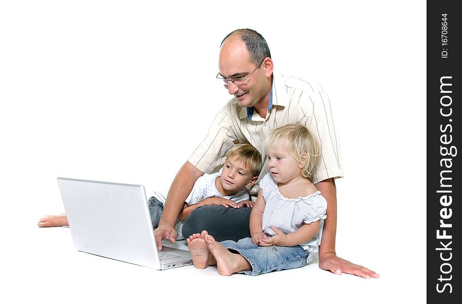 Studio shot of father and two kids with laptop over white