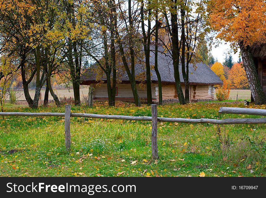 Wooden houses in autumn trees taken in park in Pirogovo museum, Kiev, Ukraine. Wooden houses in autumn trees taken in park in Pirogovo museum, Kiev, Ukraine