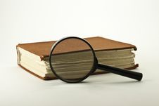 Old Book With Magnifying Glass Royalty Free Stock Photo
