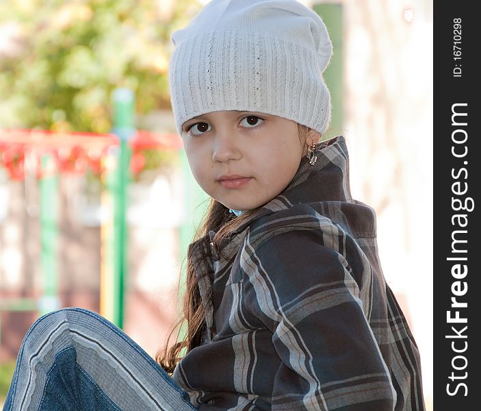 Beautiful look of the child. She walks in the courtyard