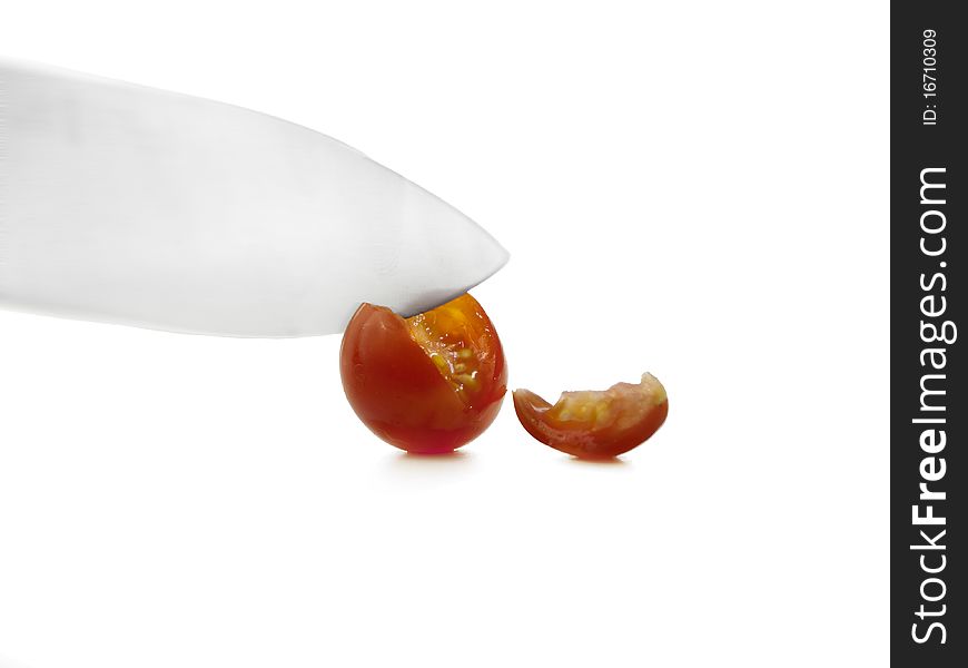 Sliced cherry tomato with knife and slice