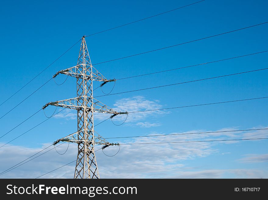 High voltage pylon against blue sky. High voltage pylon against blue sky