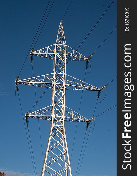 High voltage pylon against blue sky. High voltage pylon against blue sky