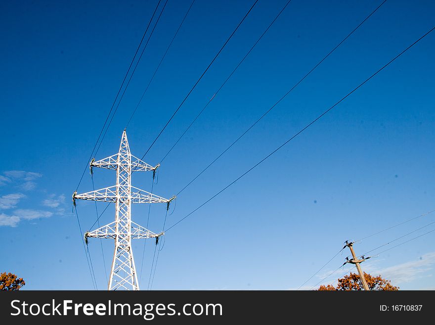 High voltage pylon against blue sky. High voltage pylon against blue sky