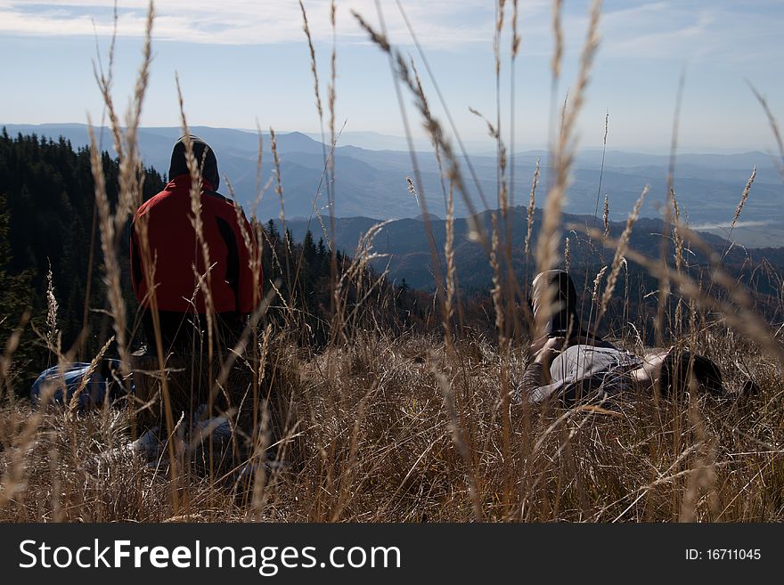 Tourists on mountain top looking. Tourists on mountain top looking