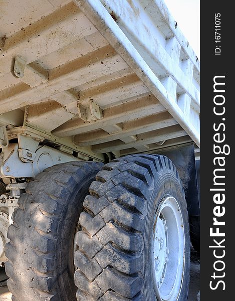Part of construction equipment, tyre and body of a big loading vehicle, shown as working and powerful construct concept.