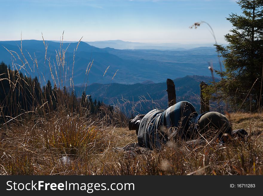 Tourists taking a nap on top of a mountain