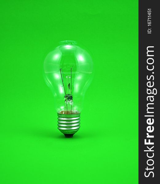 Compact light bulb isolated on green background. Compact light bulb isolated on green background