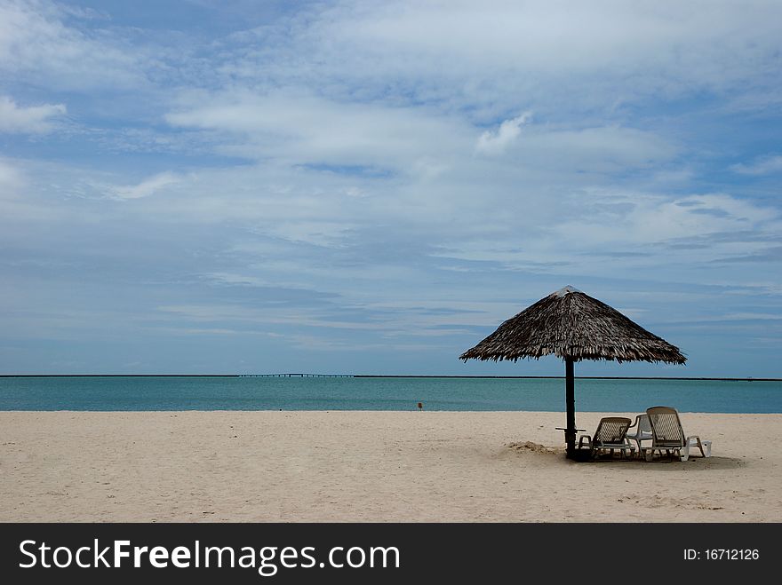 A sunbathing seat facing the ocean and blue sky