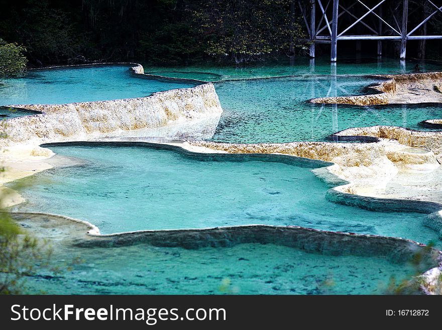 Colourful pools and temple in Huanglong Scenic and Historic Interest Area