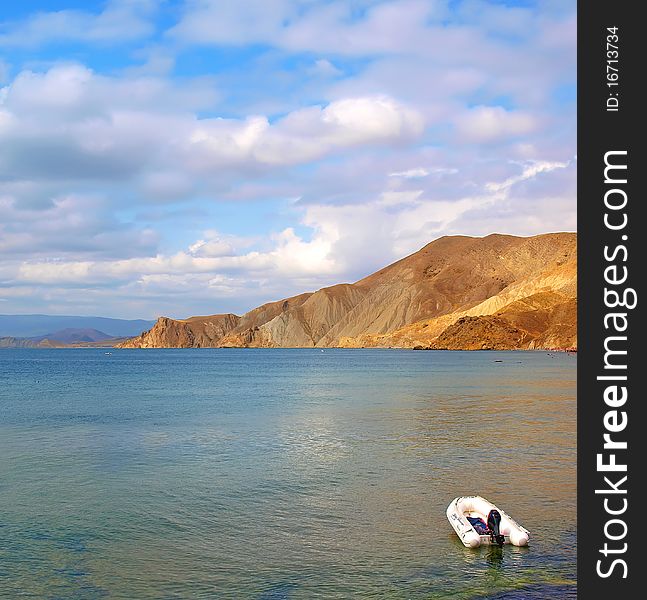 Motor Boat At Sea With Mountains And Sky