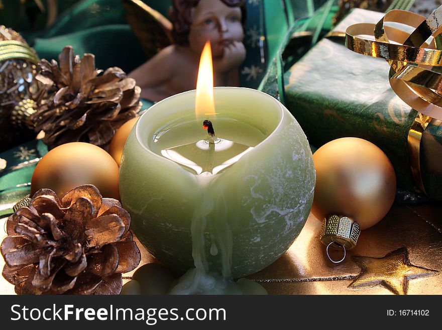 Burning candle with Christmas gift