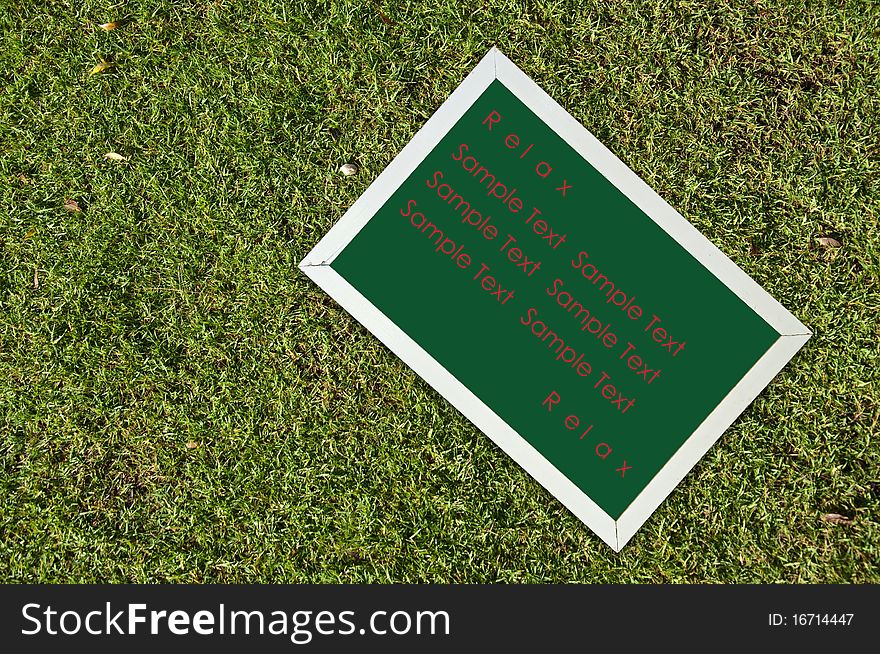 Chalkborad on green grass with sample text