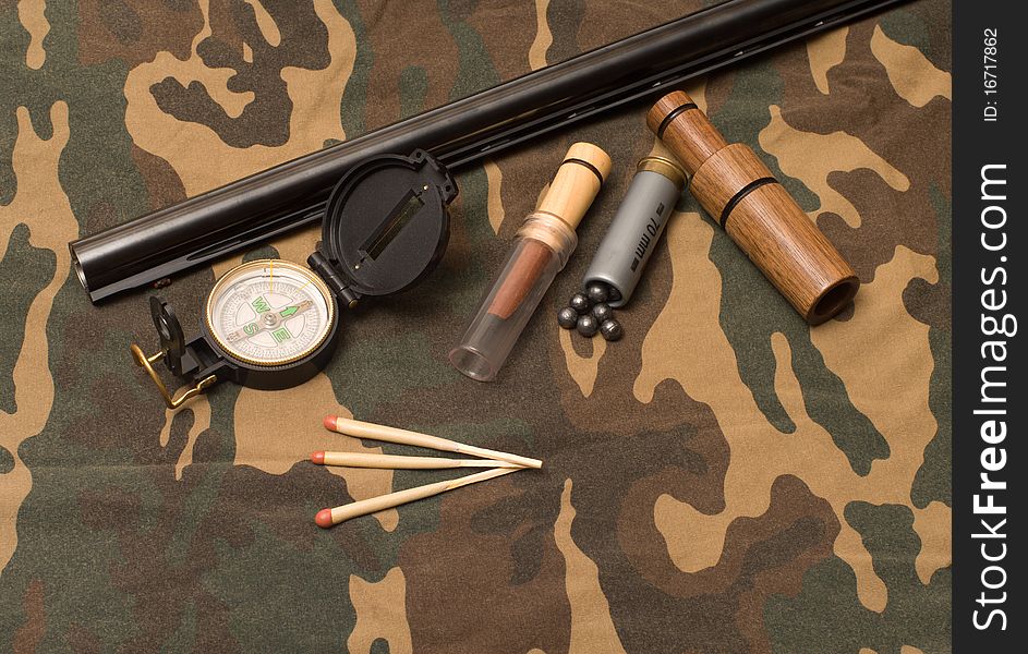 Subjects of the hunting ammunition on a camouflage fabric. Subjects of the hunting ammunition on a camouflage fabric.