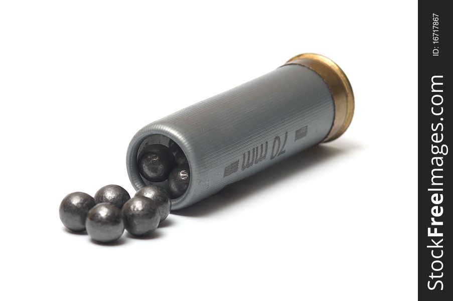 The hunting cartridge with a case-shot charge on a white background. The hunting cartridge with a case-shot charge on a white background.