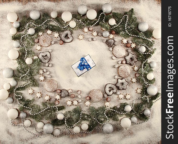 Christmas frame of cookies, stars, balls, snow and a present
