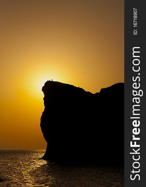 Silhouette of a man on the mountain at sunset