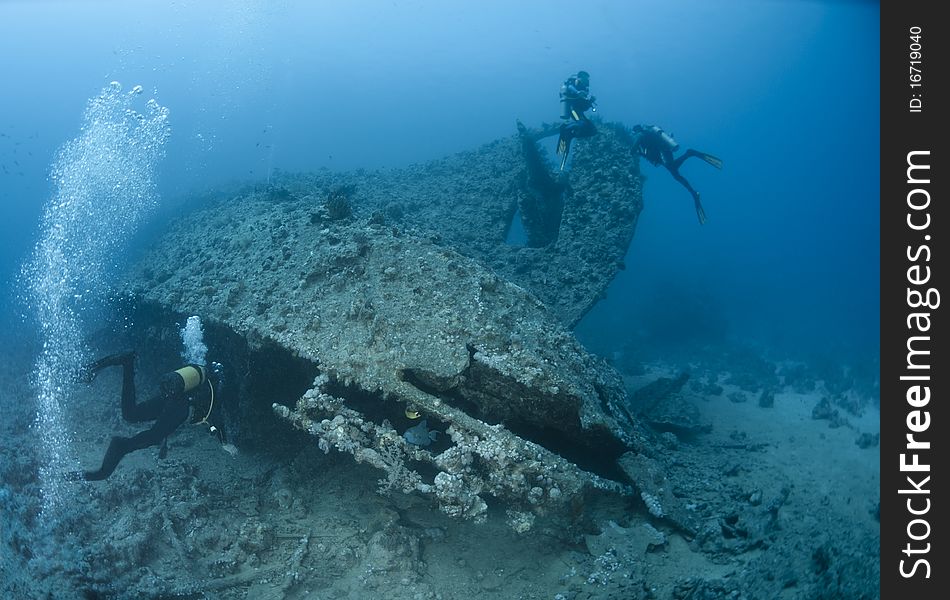 Scuba diver entering a shipwreck. Dunraven, Beacon rock, Red Sea, Egypt.