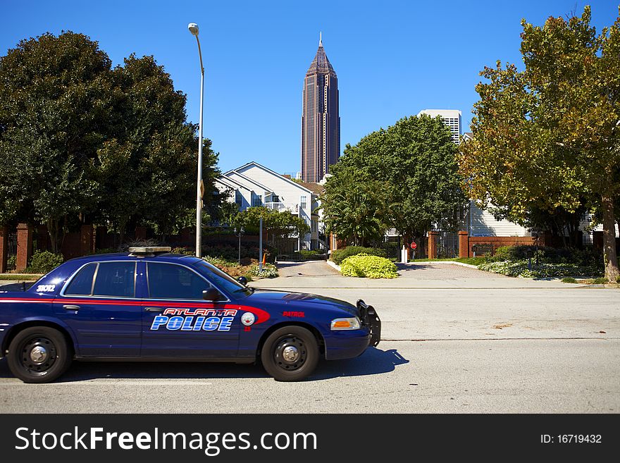 Sunny day in Atlanta. Hose on the street and police car. Sunny day in Atlanta. Hose on the street and police car.
