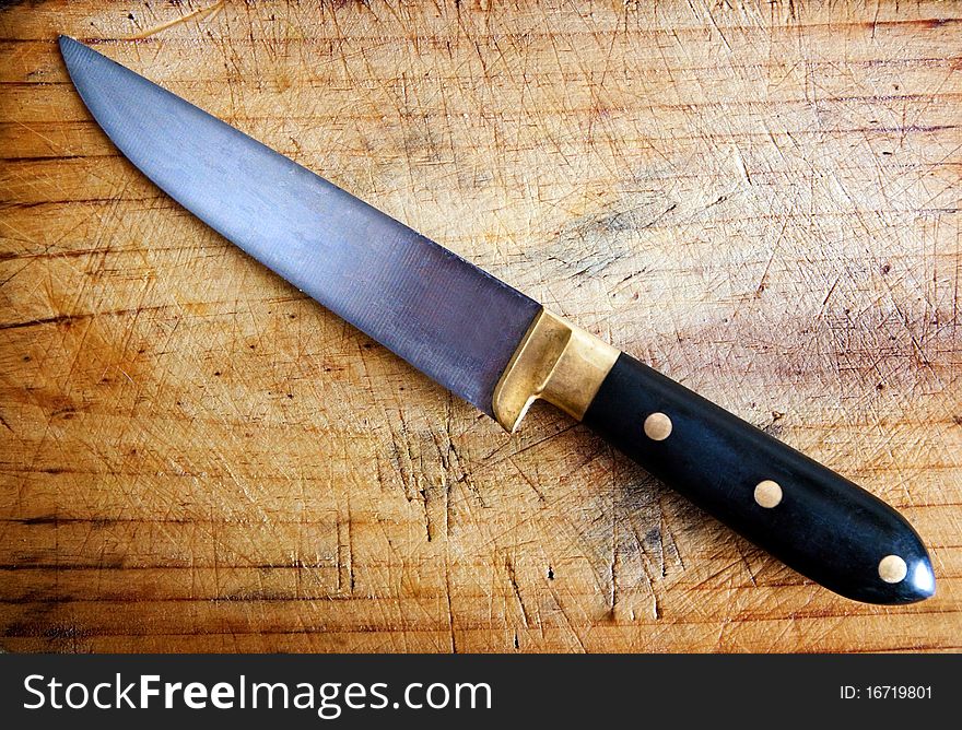 Close up image of kitchen knife with cutting board. Close up image of kitchen knife with cutting board