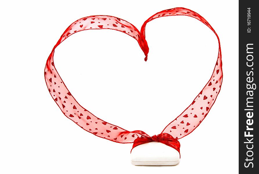 A white jeweler's box with a big red ribbon with little hearts on it and shaped into a heart. Shot on white background. A white jeweler's box with a big red ribbon with little hearts on it and shaped into a heart. Shot on white background.