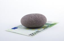 Euro Banknote Pressed Down By A Stone Royalty Free Stock Photos