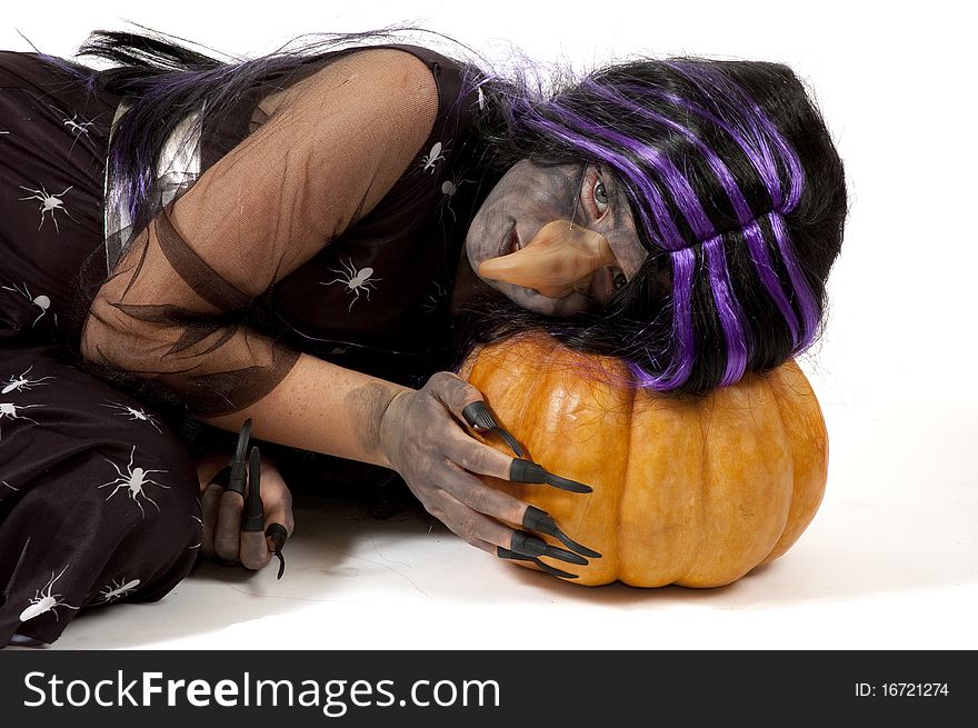 Girl Dressed Up As A Witch Sleeping On A Pumpkin