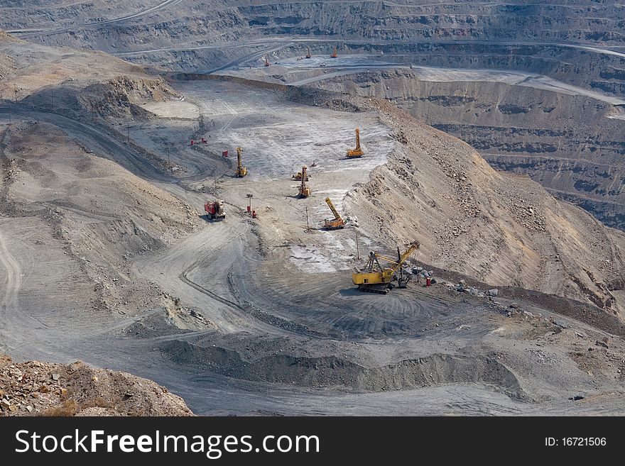 Powerful machinery working at the open stone quarry