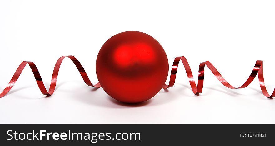 Red bauble with the red ribbon on the white background. Red bauble with the red ribbon on the white background