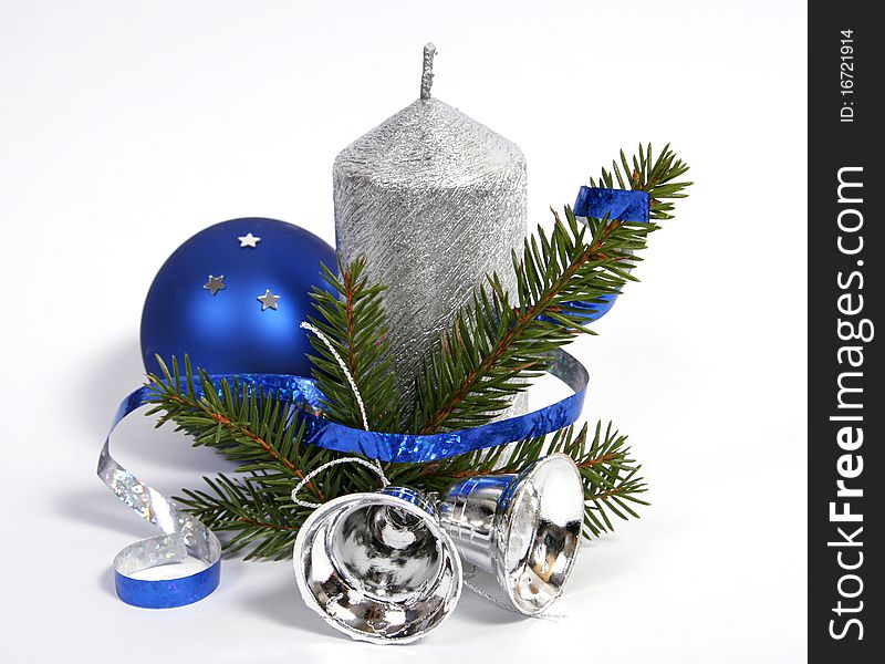 Silver candle with the twig of the spruce and bells. Silver candle with the twig of the spruce and bells