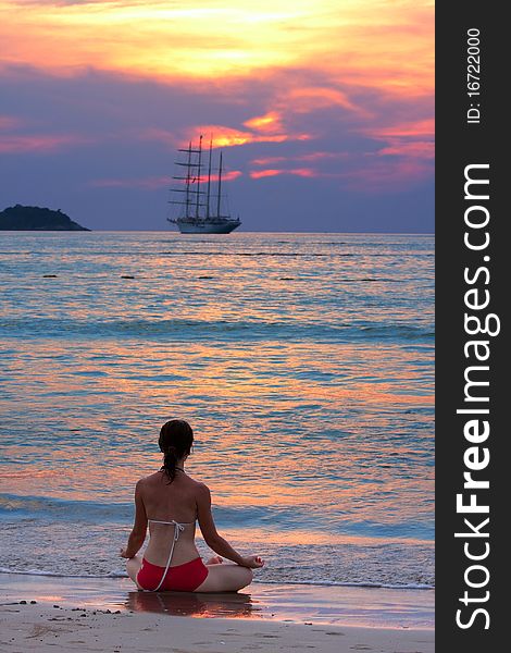 Woman meditating at the beach