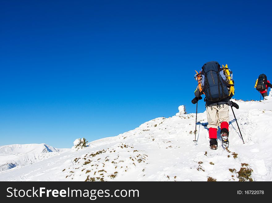 Hiker in winter in mountains