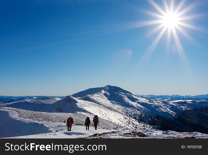 Hiker in winter in mountains