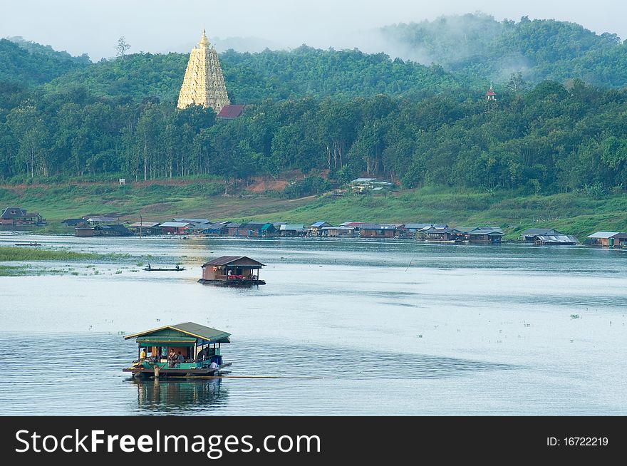 Houseboat and pagoda at Sangklaburi Thailand