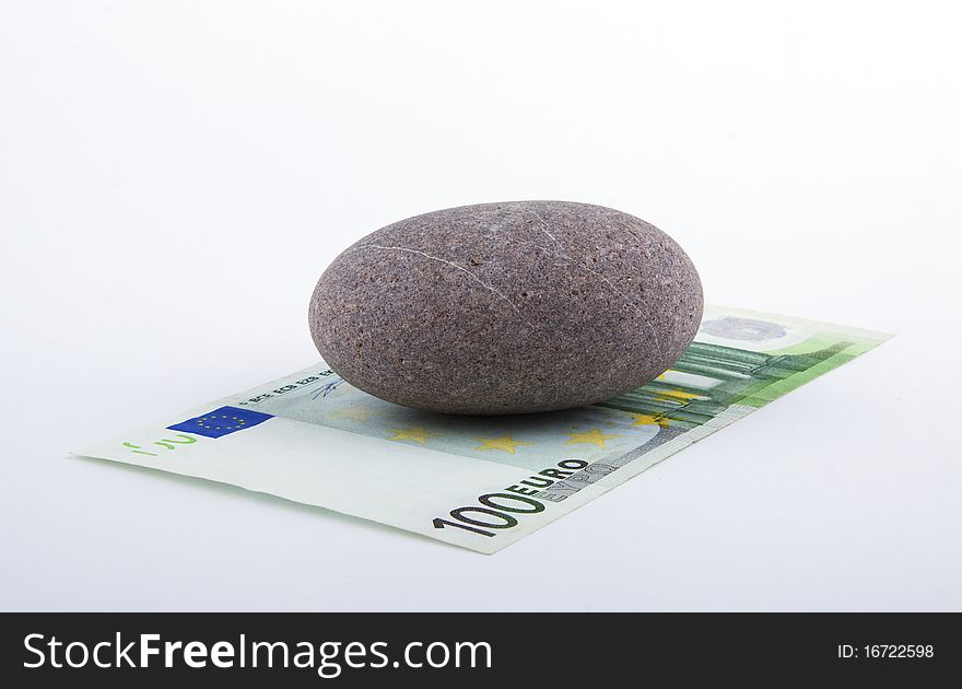 Banknote of euro with a stone the taxation concept. Banknote of euro with a stone the taxation concept