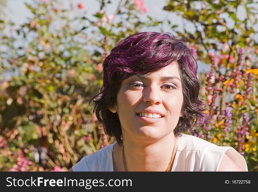 A young woman in a sunlit garden. A young woman in a sunlit garden.