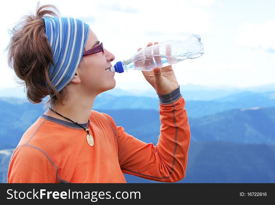 Hiker drinks in Carpathian mountains