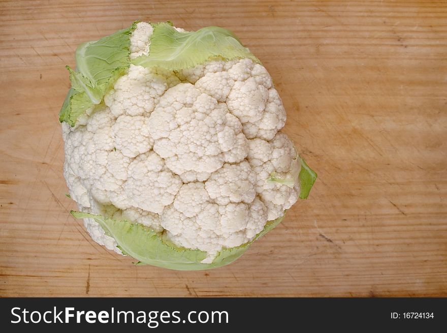 Fresh clean organic cauliflower head on table board