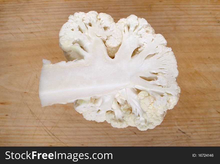 Fresh clean organic cauliflower head on table board