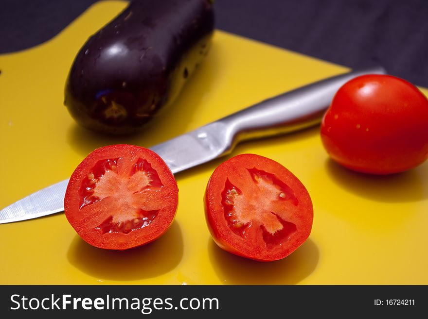 On the board are sliced tomato, eggplant. On the board are sliced tomato, eggplant