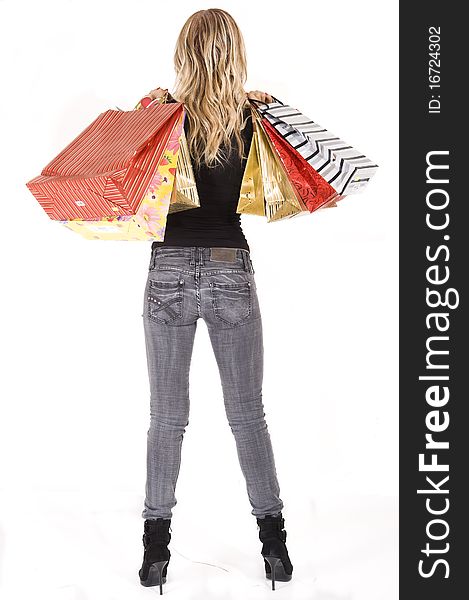 blond woman with shopping bags smiling happily. blond woman with shopping bags smiling happily