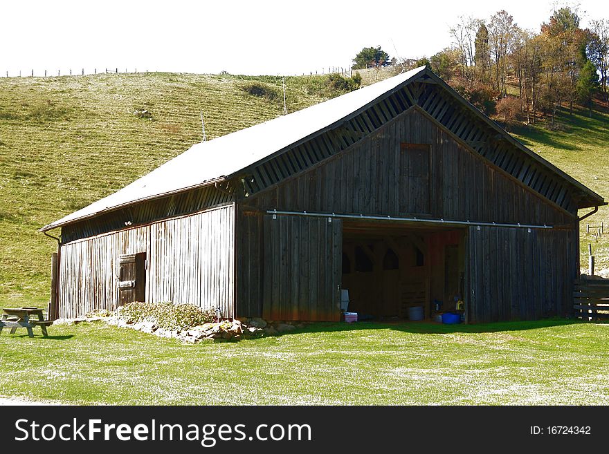 Old plank barn with hills in background